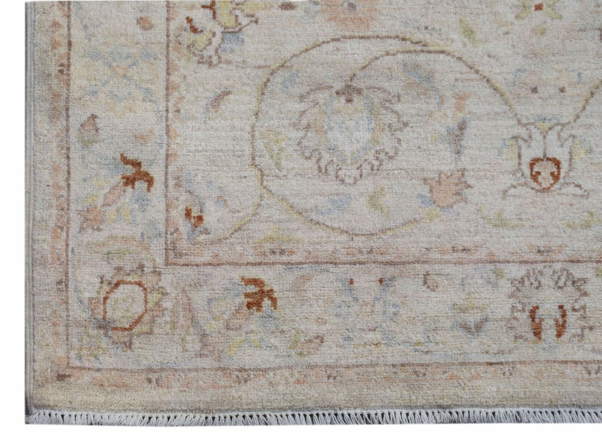 A handmade Afghan Chobi rug featuring traditional floral patterns in soft, earthy tones.