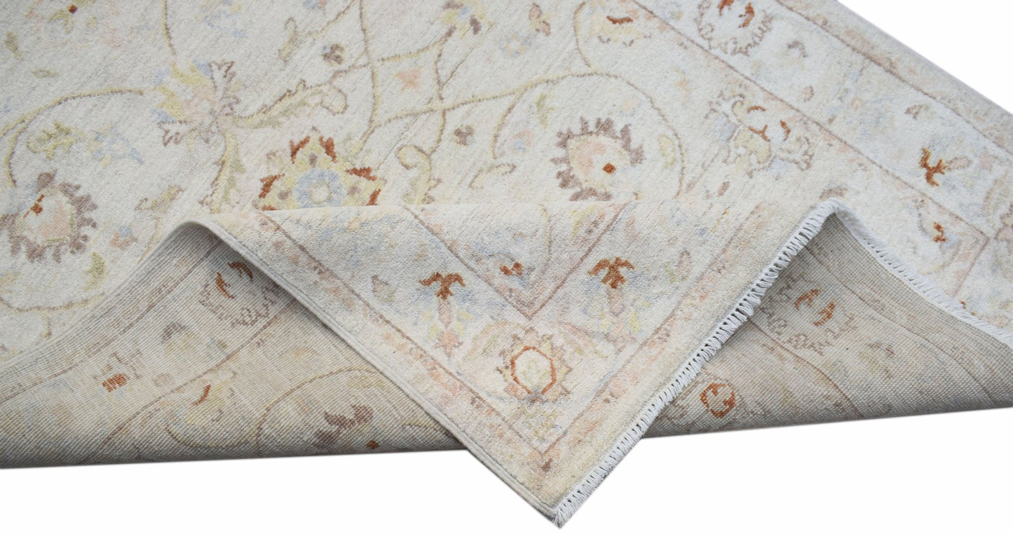 A handwoven Afghan Chobi rug with a cream background and traditional floral patterns.
