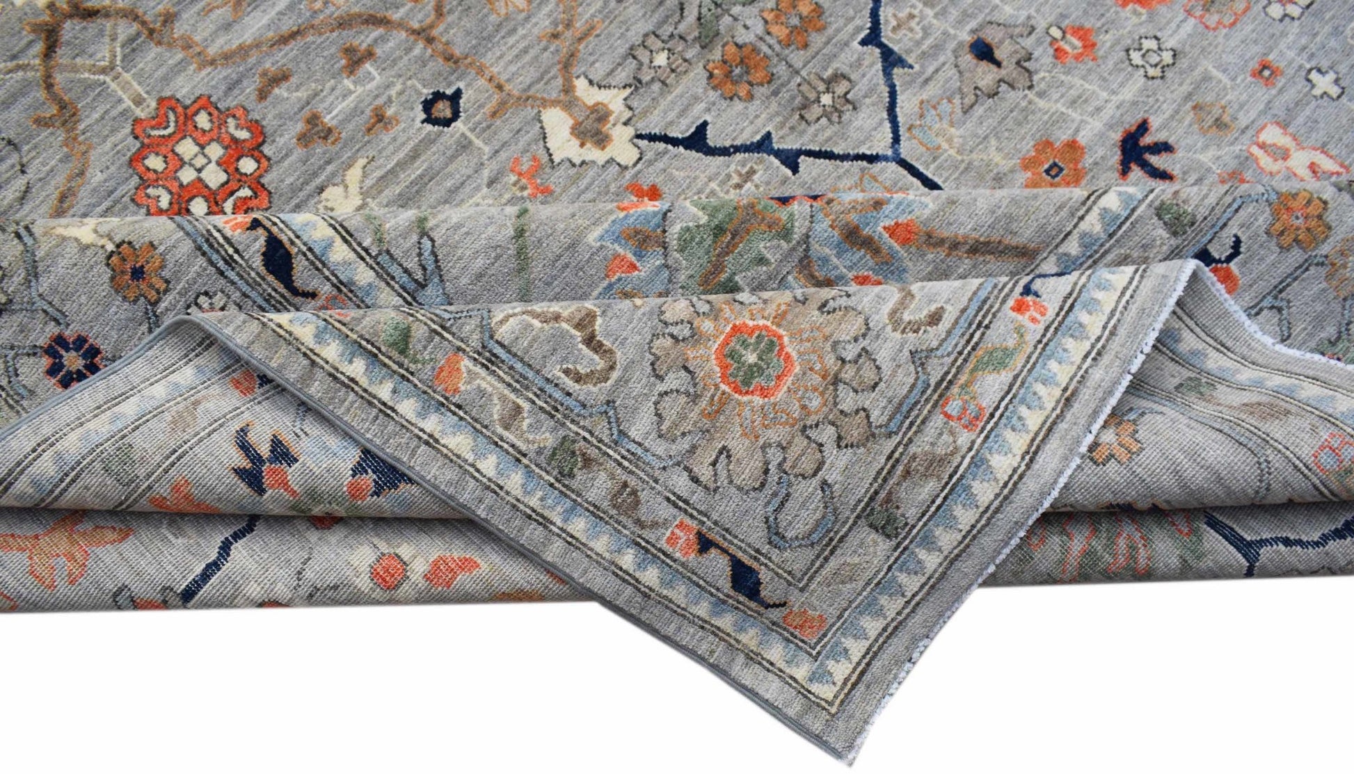 A handwoven Afghan Chobi rug featuring a traditional floral pattern in grey, orange, and blue.