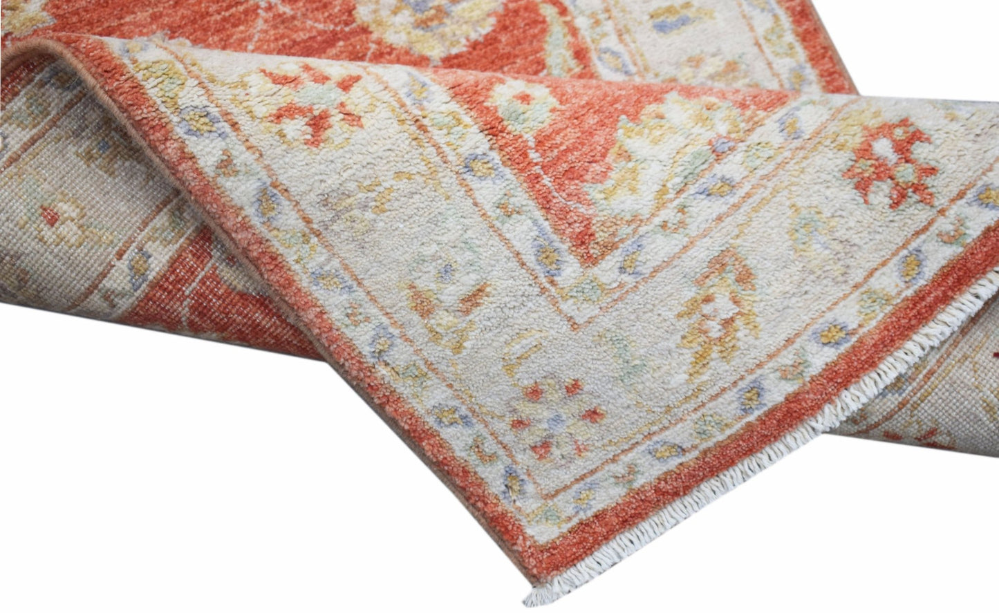 A handwoven Afghan Chobi runner featuring a traditional floral pattern in rust and cream tones.