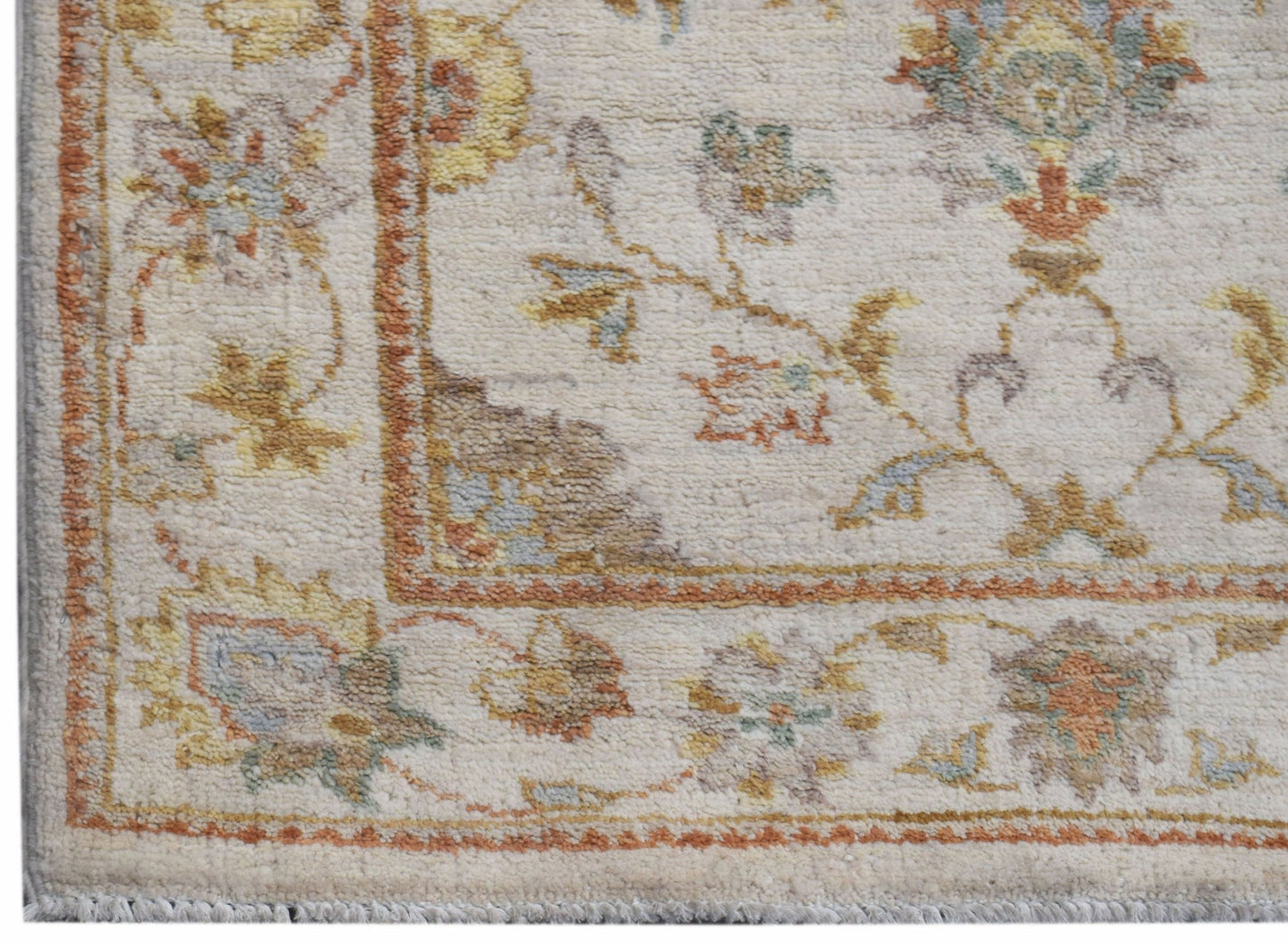 A handmade Afghan Chobi runner featuring a traditional floral pattern in soft, earthy tones.