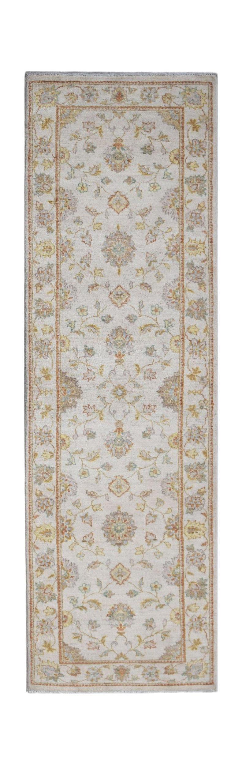 A handmade Afghan Chobi runner rug featuring a traditional floral pattern in soft earthy tones.