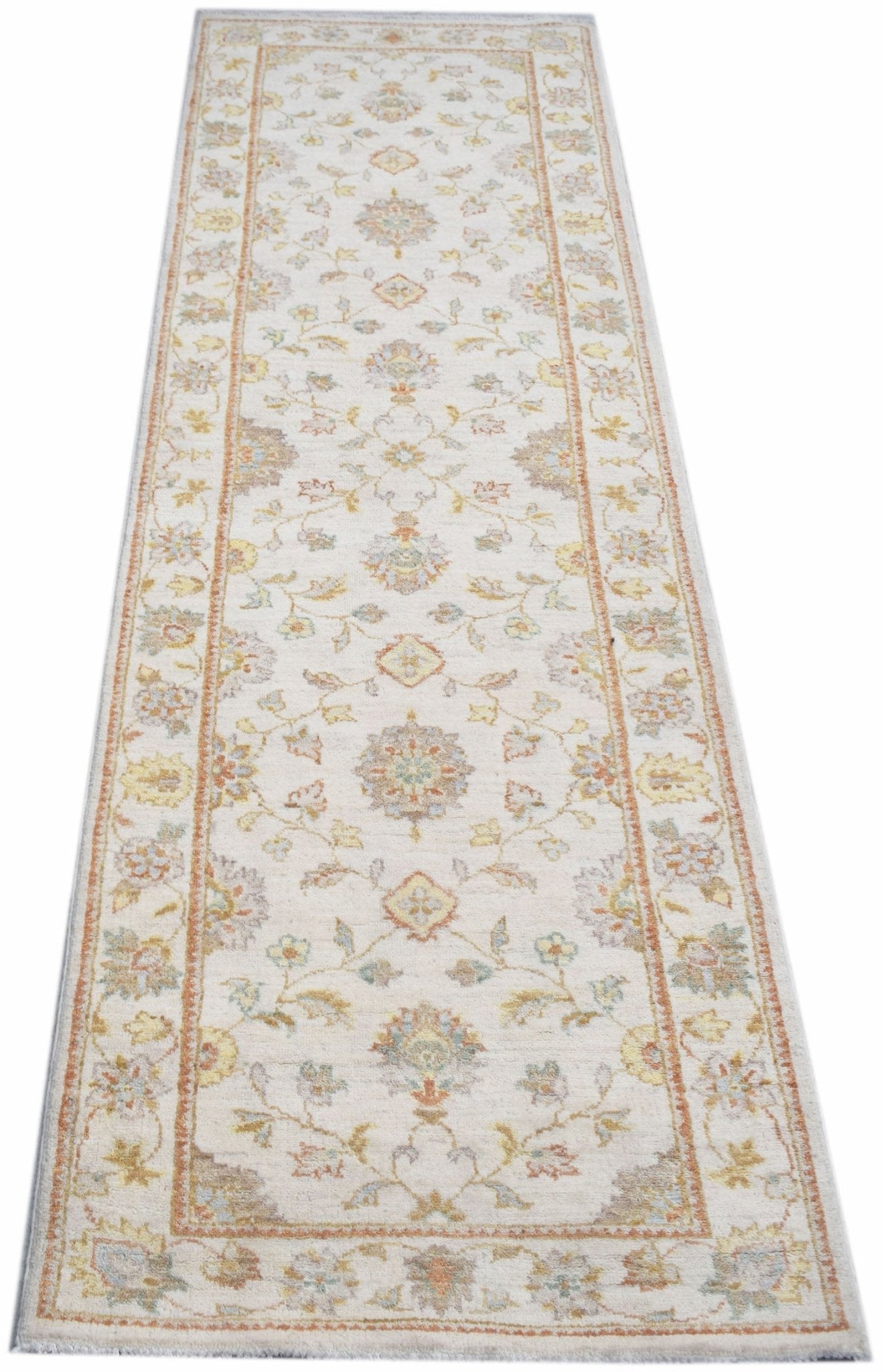 An Afghan Chobi runner rug featuring a traditional floral pattern in soft, earthy tones.