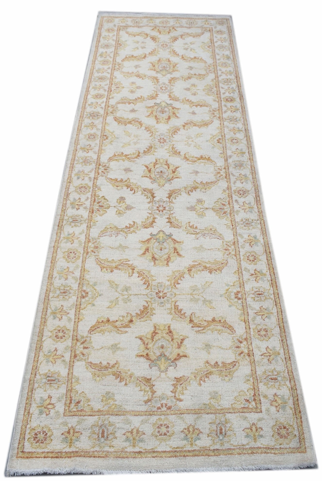 A handmade Afghan Chobi runner rug featuring traditional floral patterns in soft earthy tones.