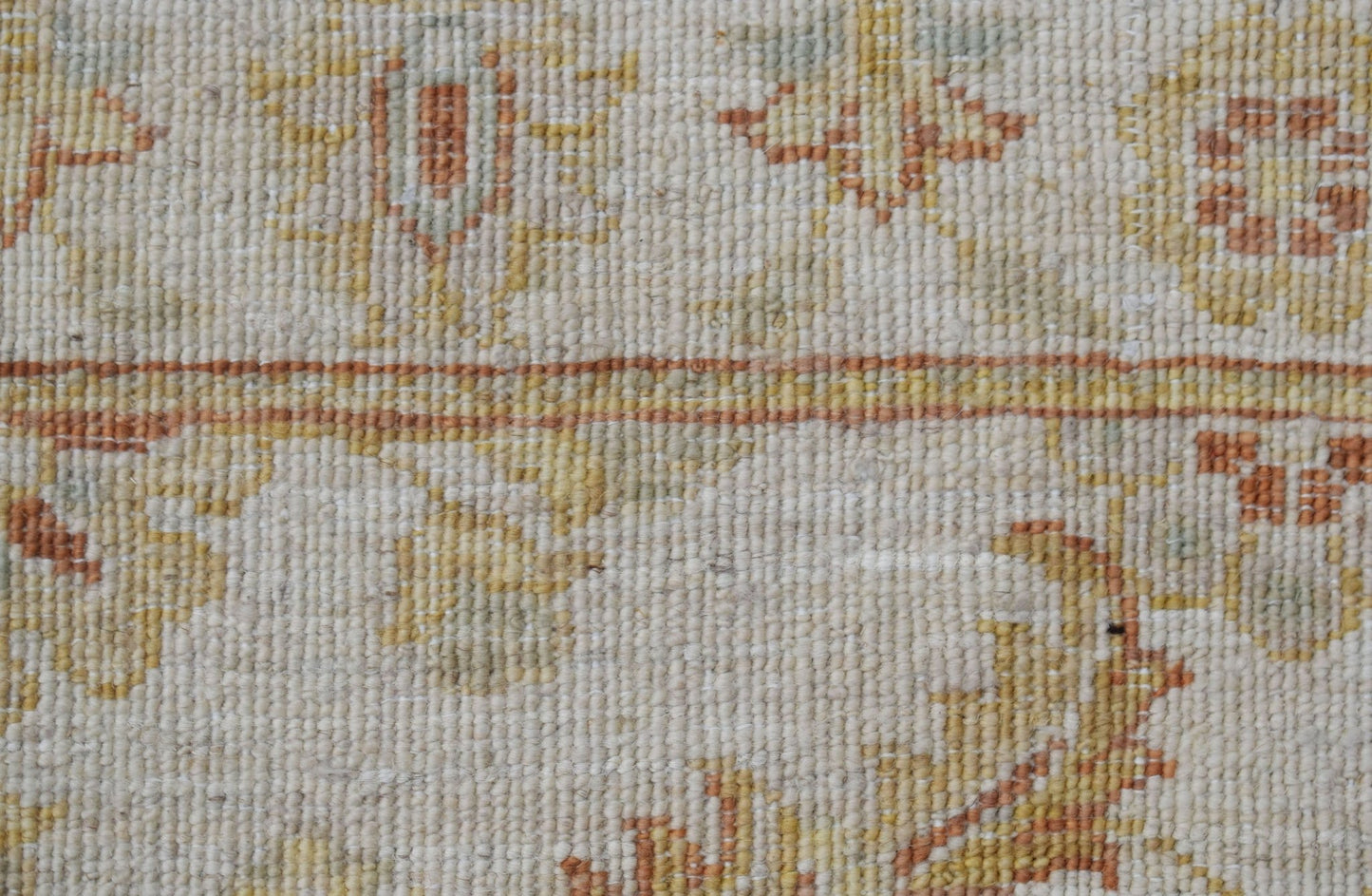 A close-up of an Afghan Chobi runner featuring traditional floral patterns in earthy wood tones.