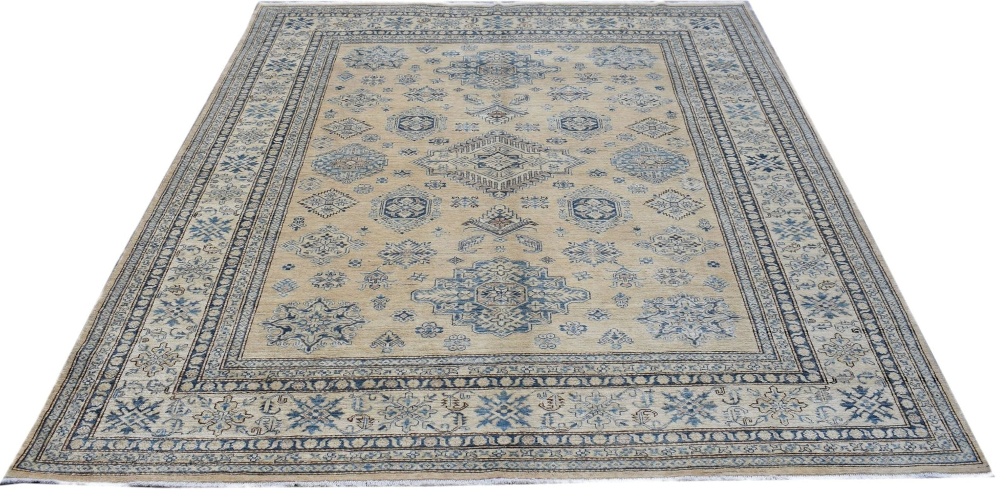 A handmade Afghan Super Kazakh rug featuring traditional blue geometric motifs on a beige field.