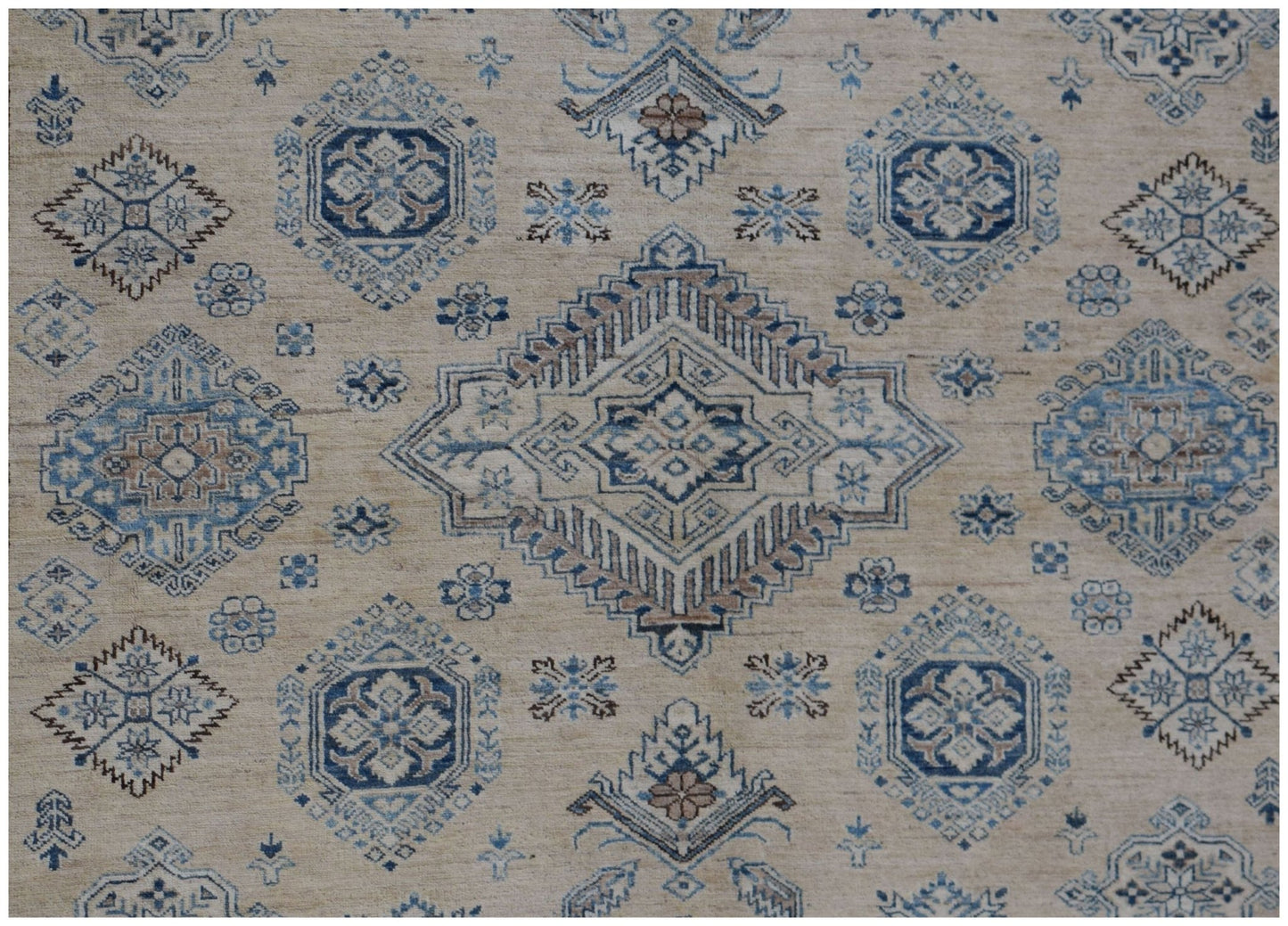 Handmade Afghan Super Kazakh rug featuring traditional geometric motifs in blue and beige tones.