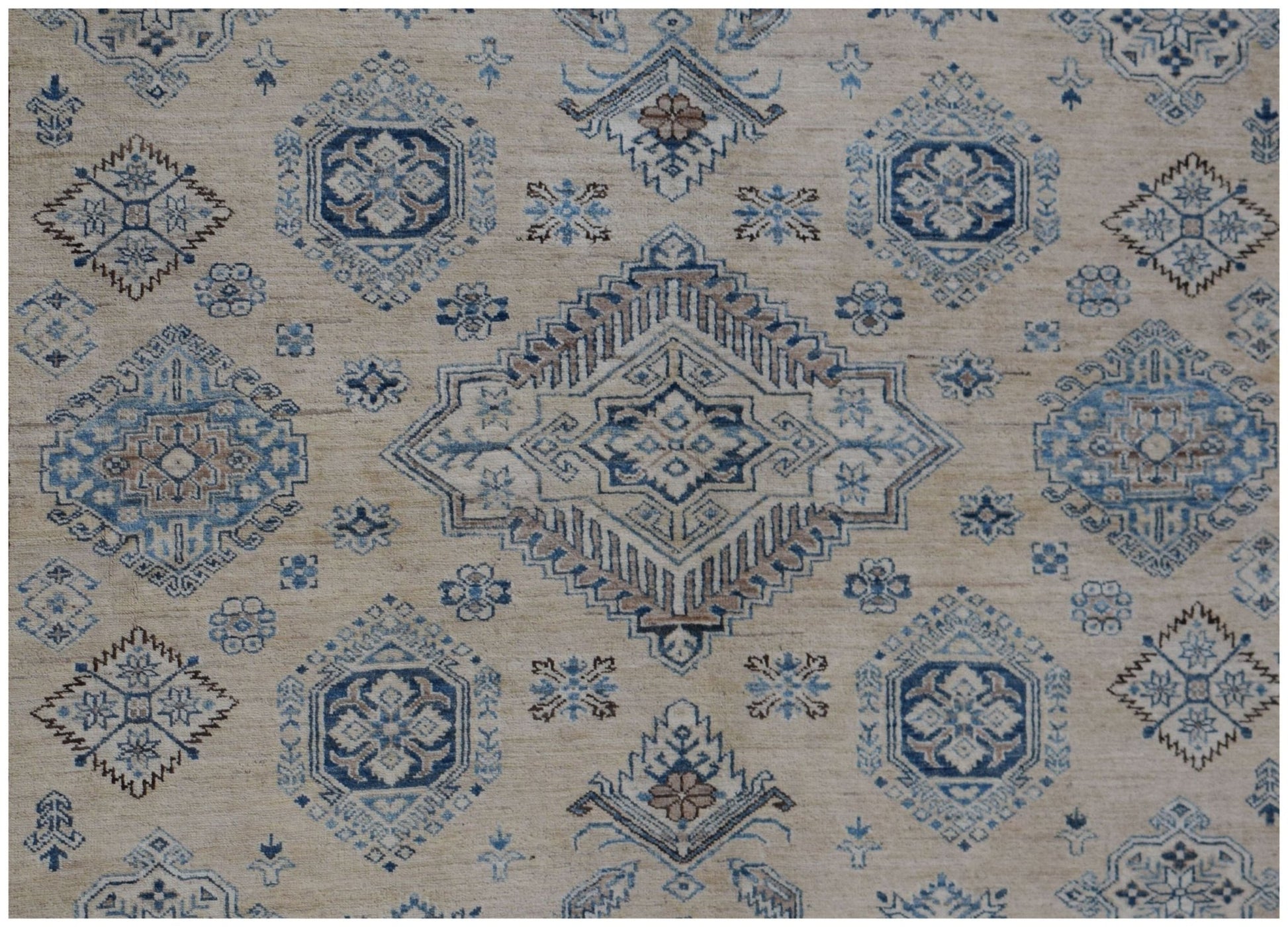 Handmade Afghan Super Kazakh rug featuring traditional geometric motifs in blue and beige tones.