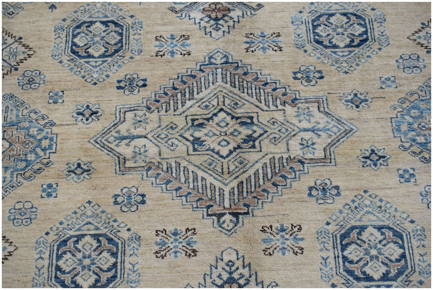 Handmade Afghan Super Kazakh rug featuring traditional blue and tan geometric patterns.