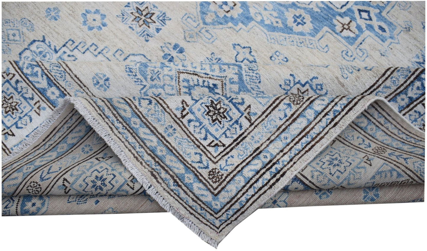A handmade Afghan Super Kazakh rug featuring traditional blue and cream geometric patterns.