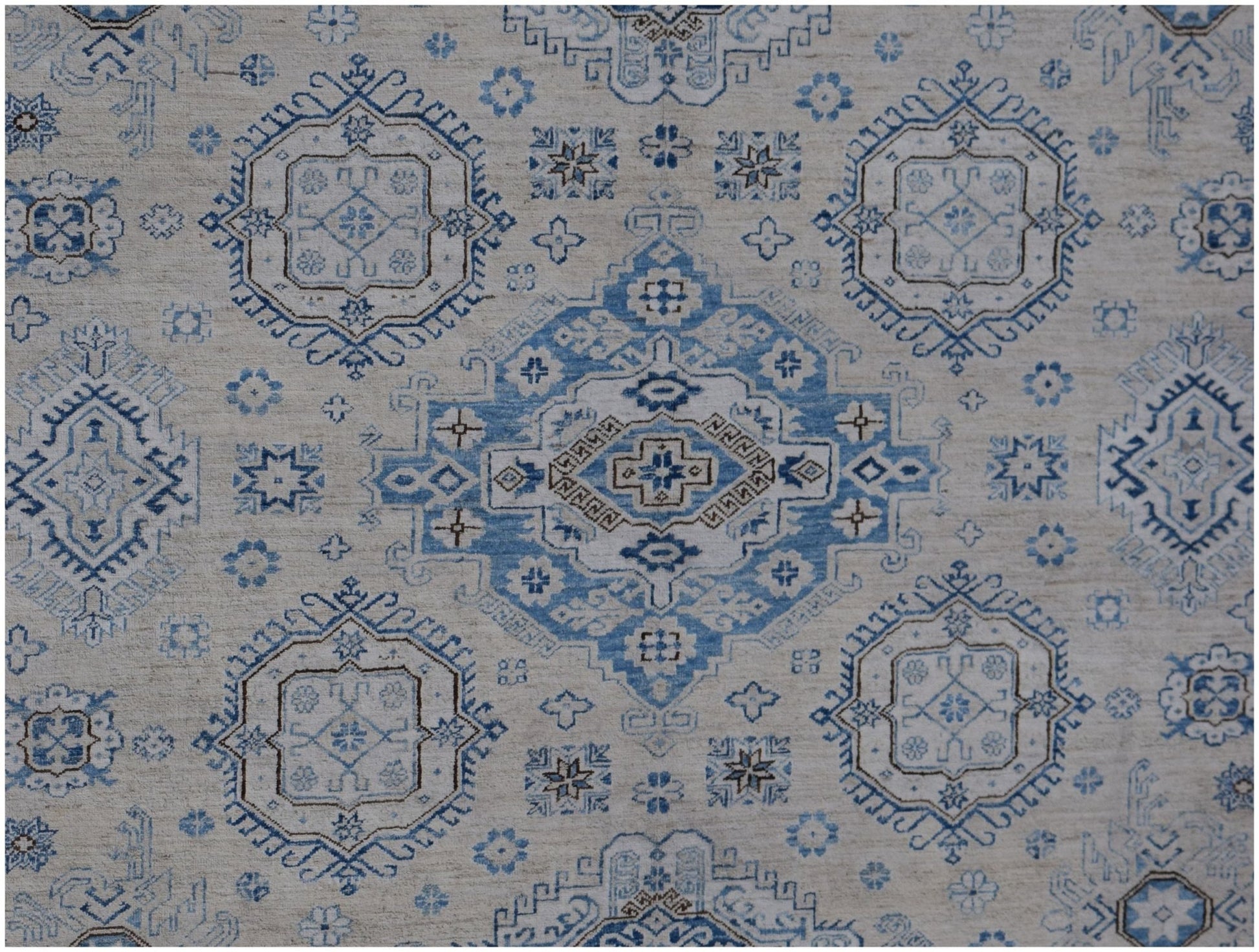 Handmade Afghan Super Kazakh rug featuring traditional blue and beige geometric medallion patterns.
