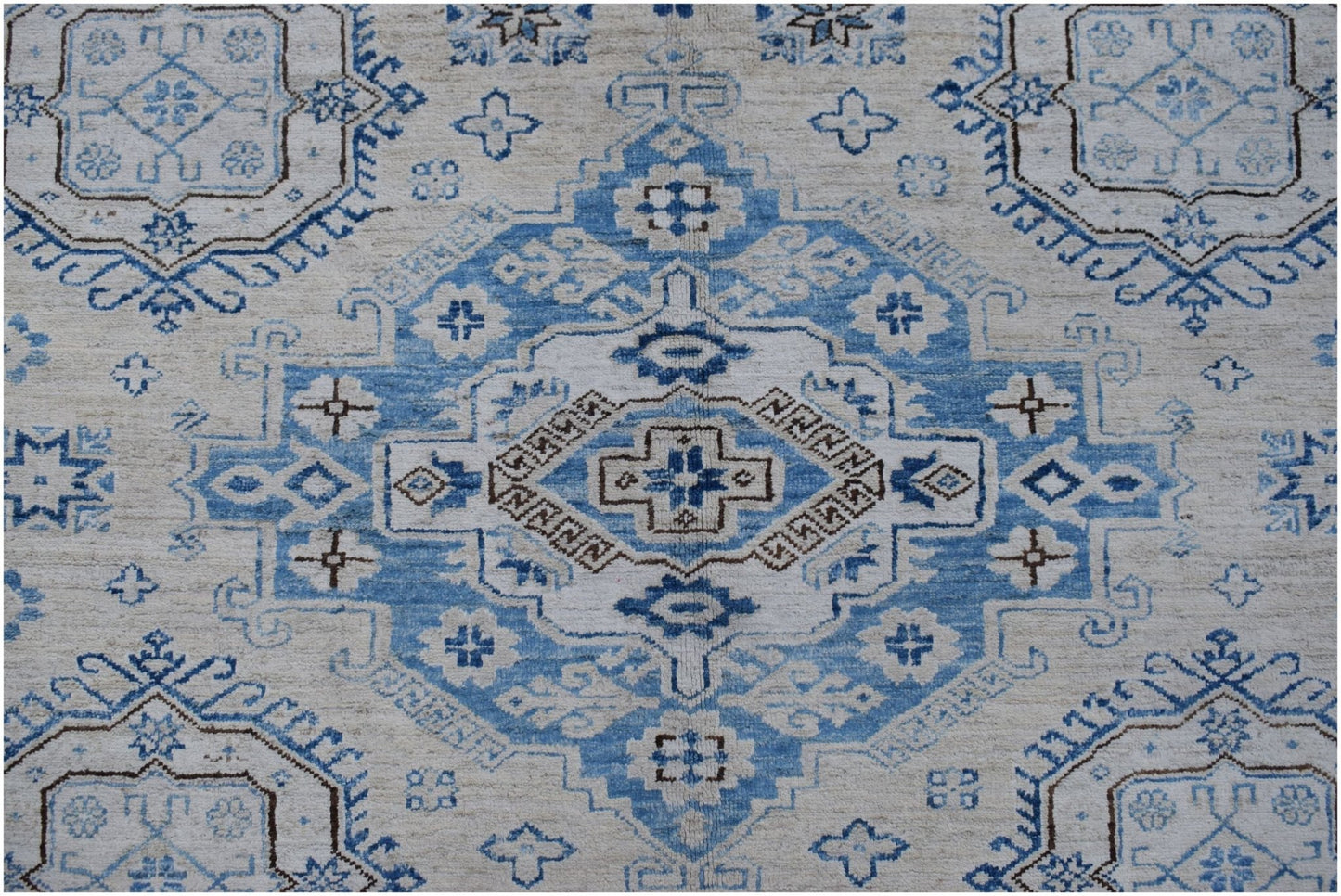 An Afghan Super Kazakh rug featuring a traditional blue and cream geometric medallion pattern.