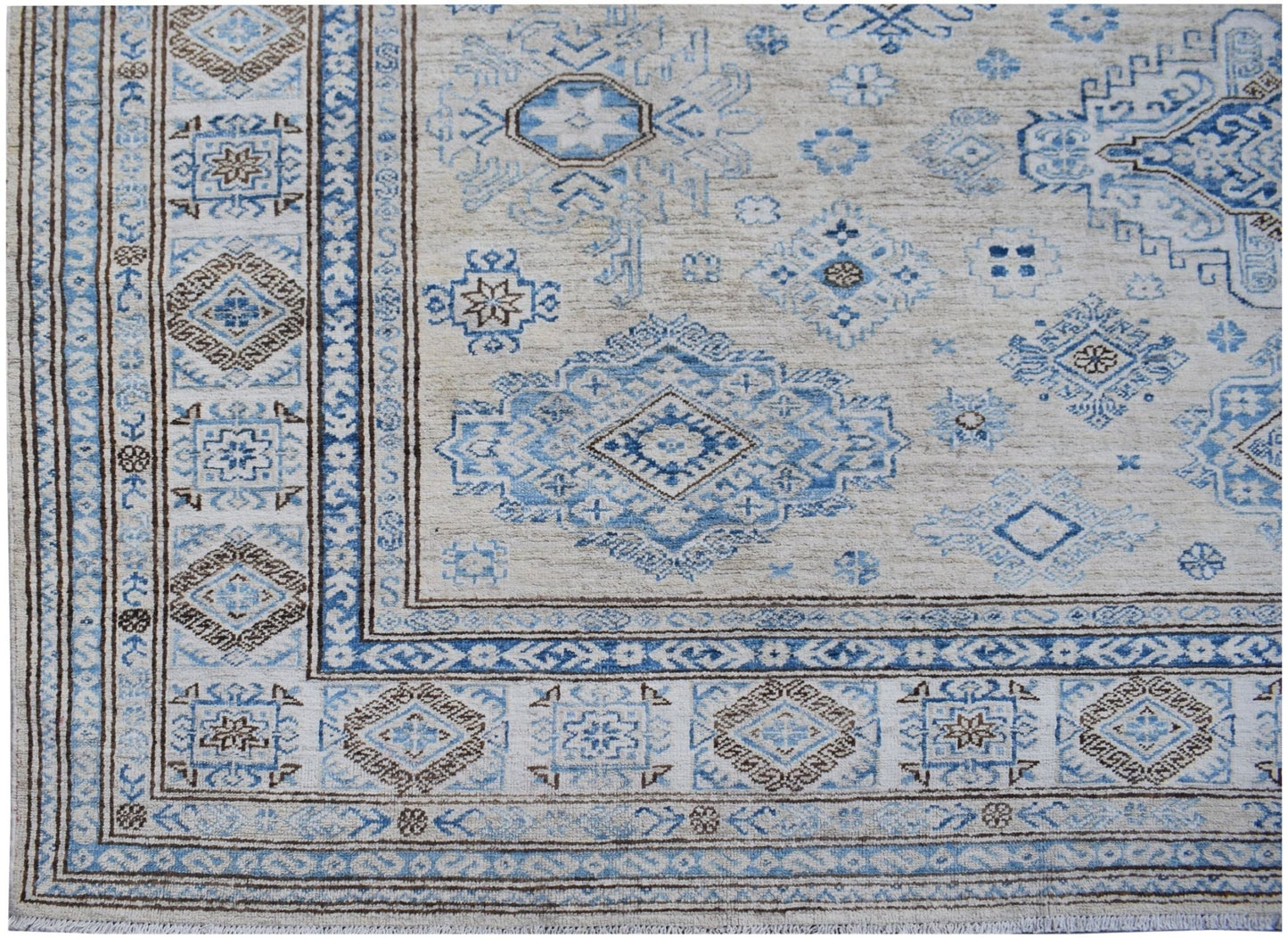 Handmade Afghan Super Kazakh wool rug featuring traditional blue and brown geometric motifs.
