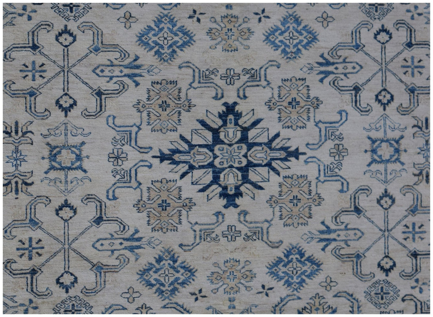 Handmade Afghan Super Kazakh rug featuring traditional blue and beige geometric motifs.