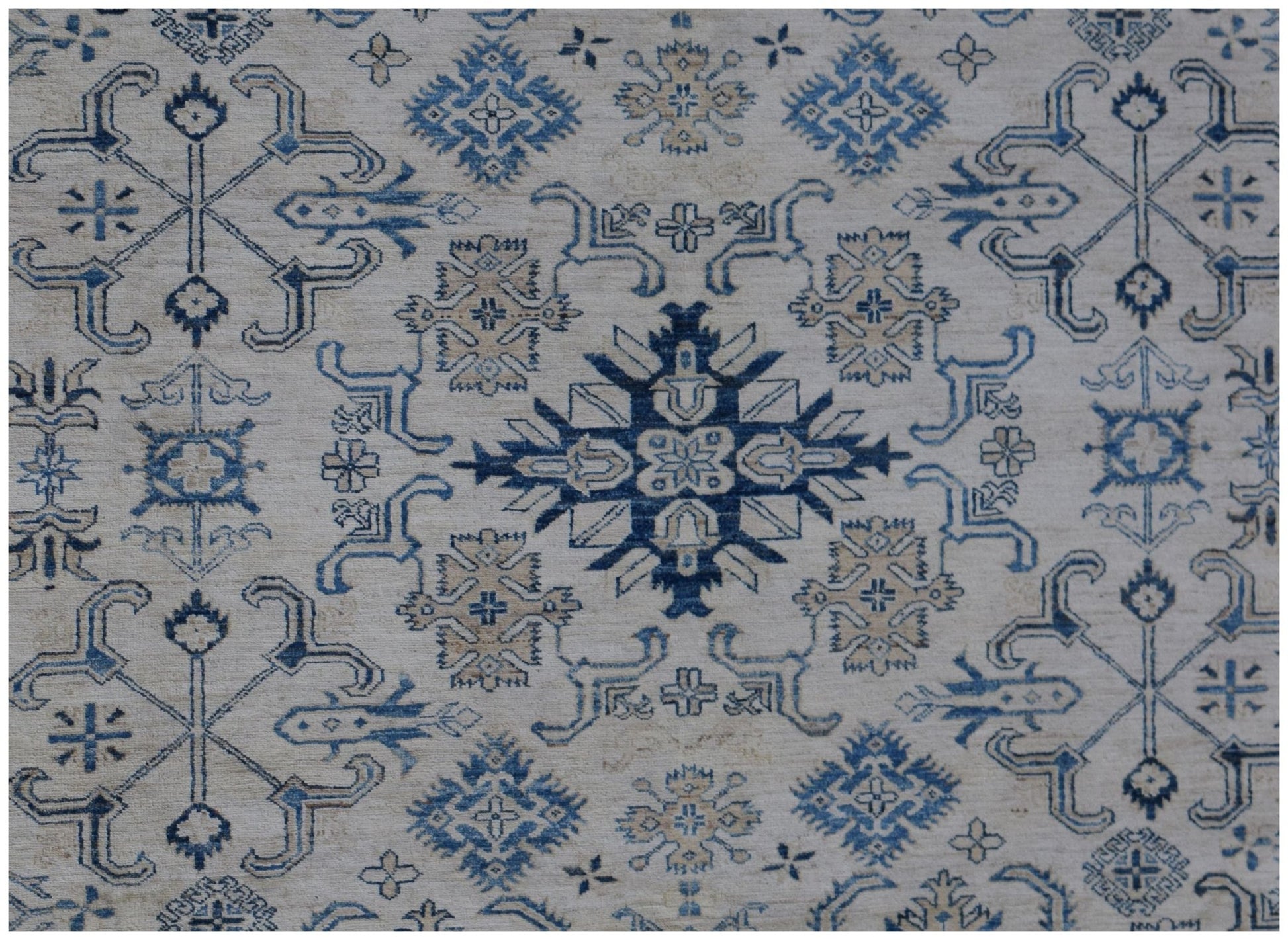 Handmade Afghan Super Kazakh rug featuring traditional blue and beige geometric motifs.