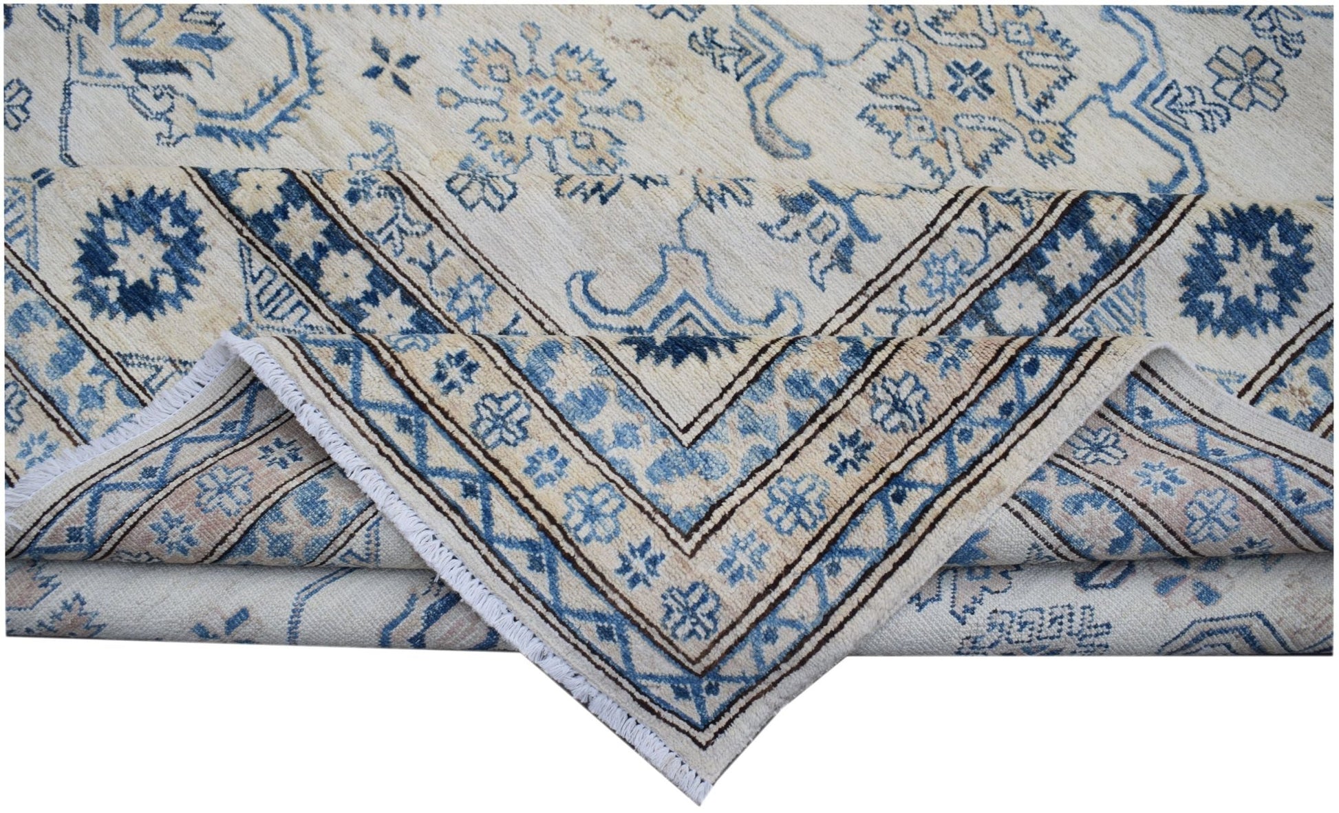 A handmade Afghan Super Kazakh rug featuring traditional blue and beige floral motifs.