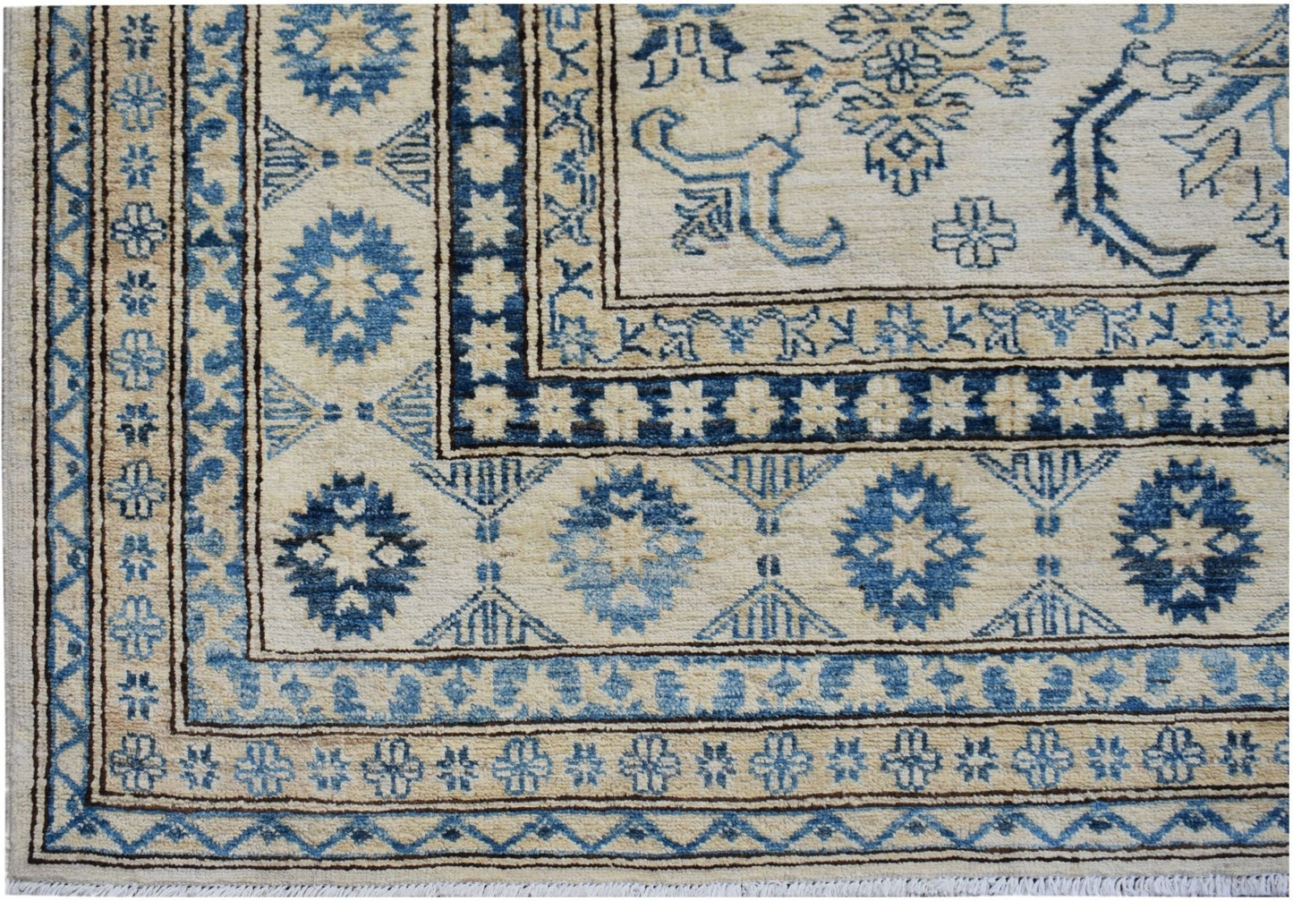 Handmade Afghan Super Kazakh rug featuring traditional blue geometric motifs on a cream background.