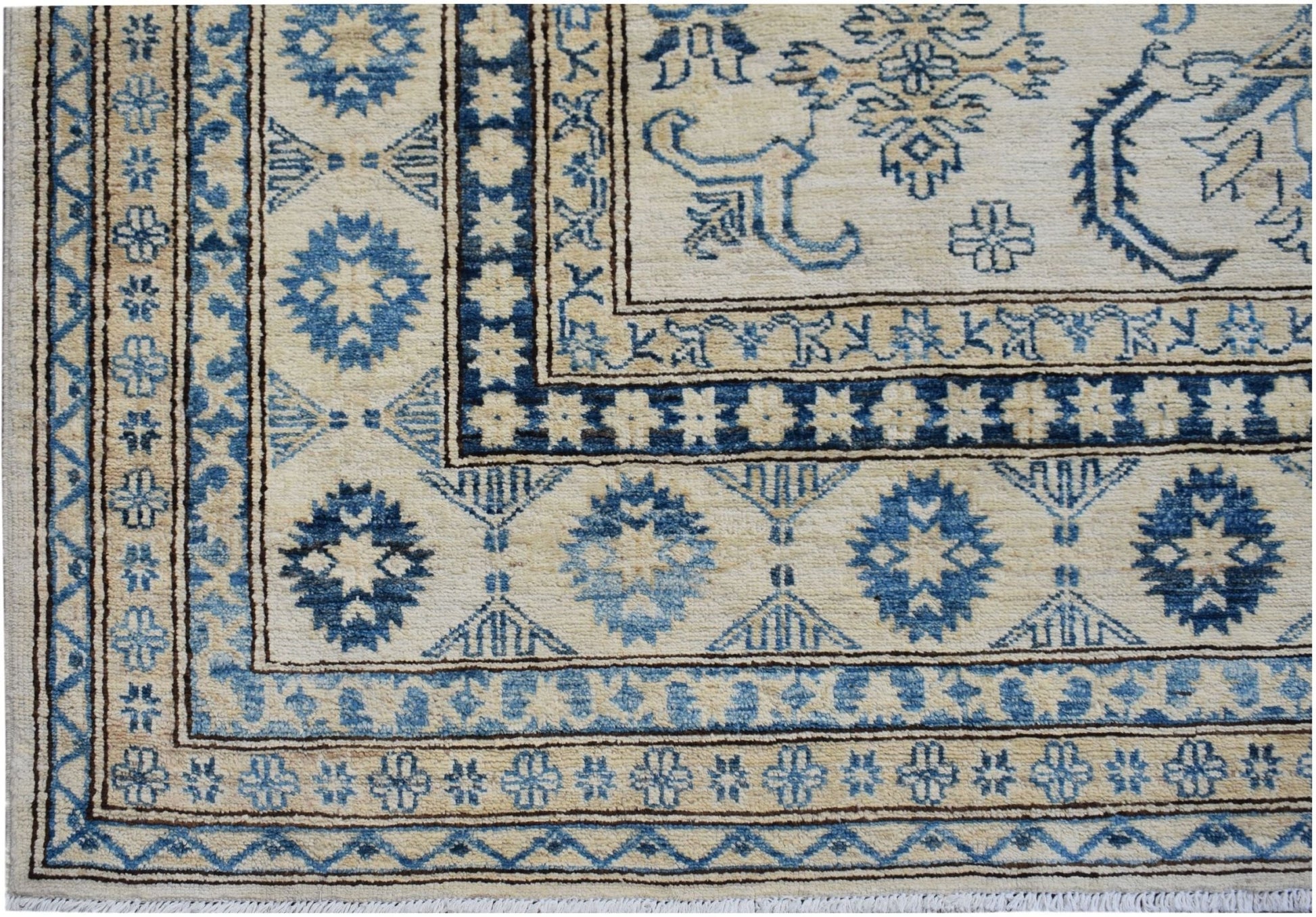Handmade Afghan Super Kazakh rug featuring traditional blue geometric motifs on a cream background.