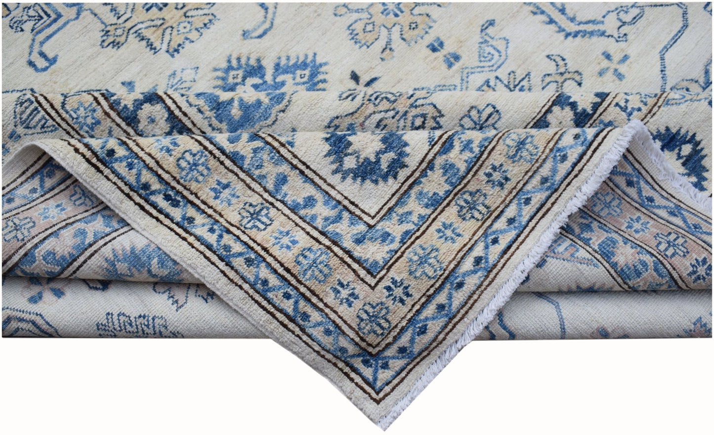 An Afghan Super Kazakh rug featuring traditional blue floral motifs on a cream wool background.