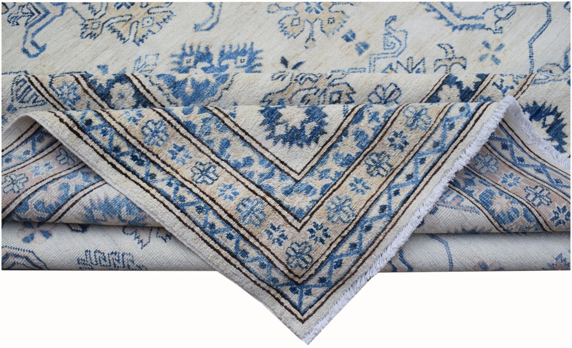 An Afghan Super Kazakh rug featuring traditional blue floral motifs on a cream wool background.