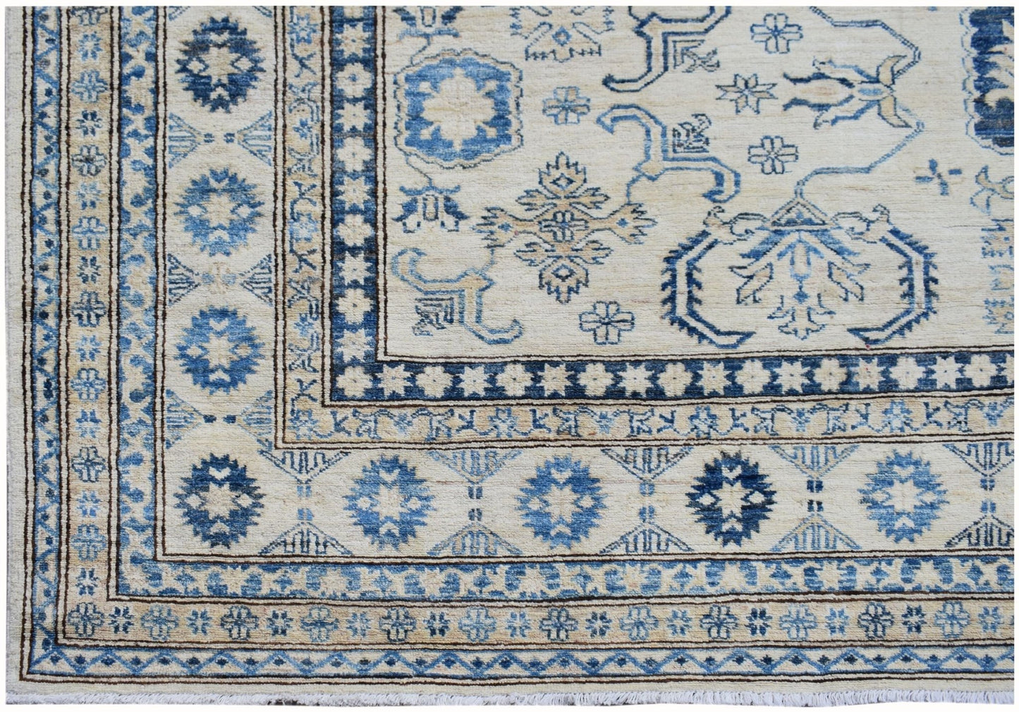 Handmade Afghan Super Kazakh rug featuring traditional blue geometric motifs on a cream background.