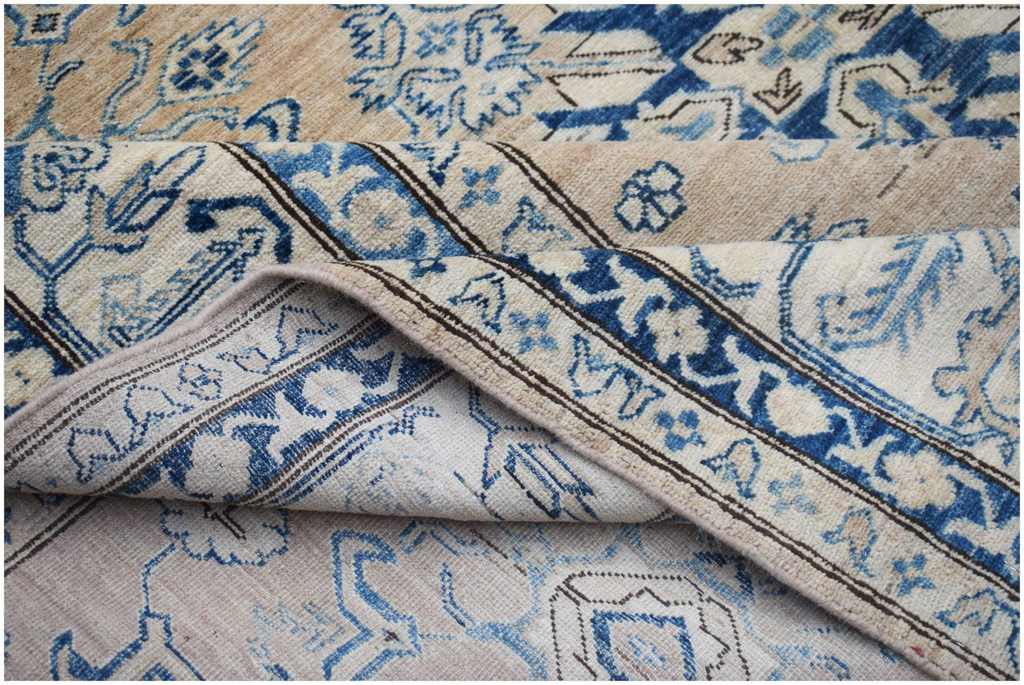 A handmade Afghan Super Kazakh rug featuring traditional blue and cream geometric patterns.