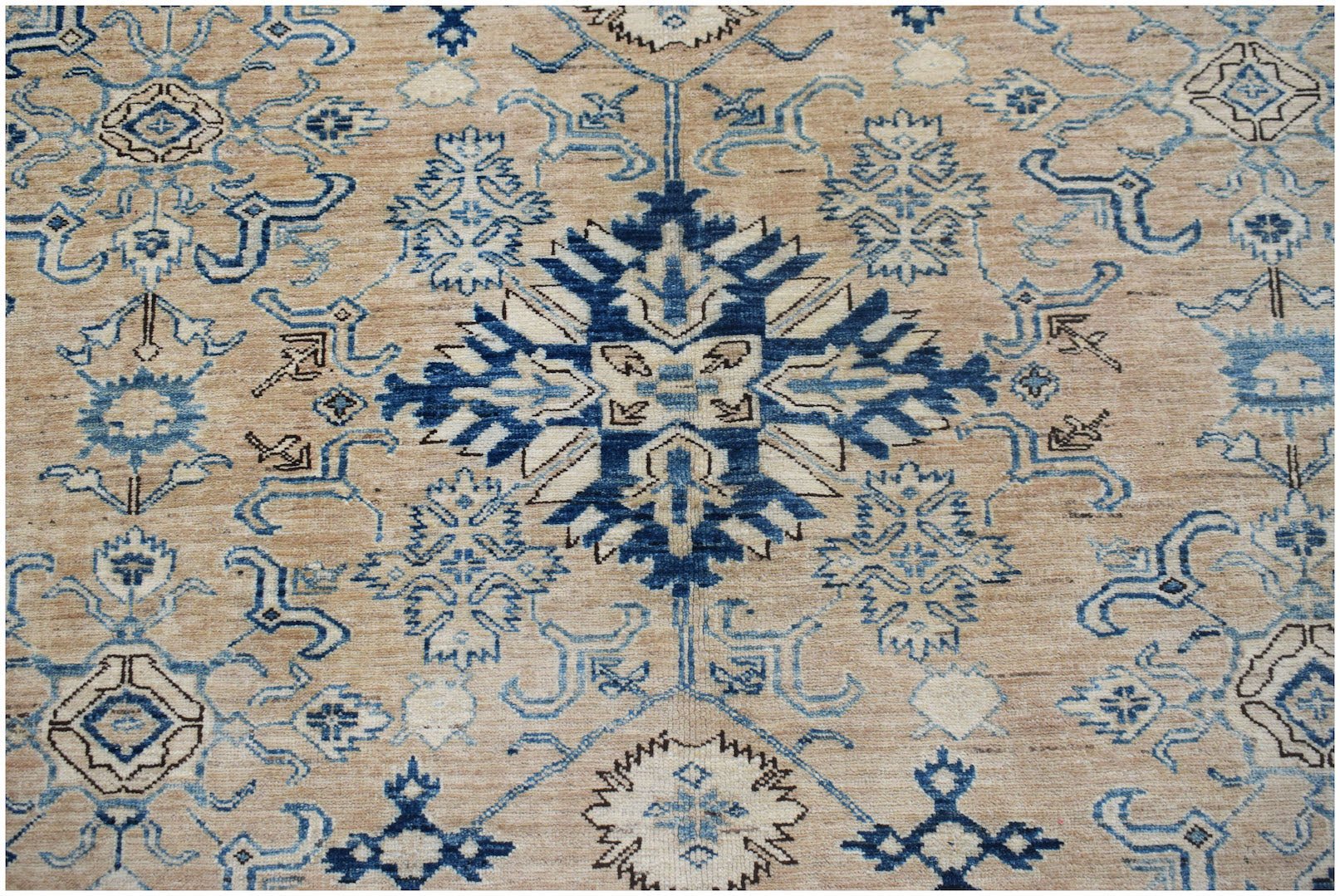 Handmade Afghan Super Kazakh rug featuring traditional blue geometric motifs on a tan wool field.