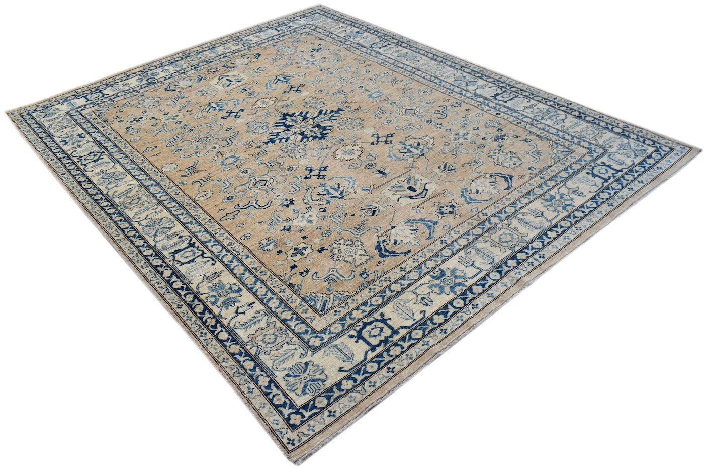 Handmade Afghan Super Kazakh rug featuring traditional blue motifs on a tan wool background.