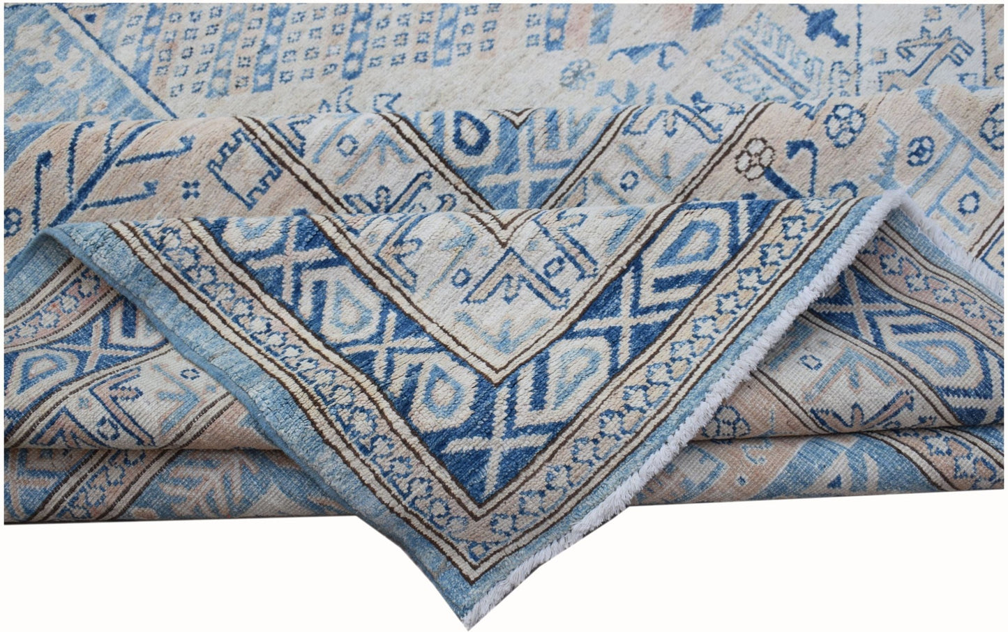A handmade Afghan Super Kazakh rug featuring traditional blue and cream geometric patterns.