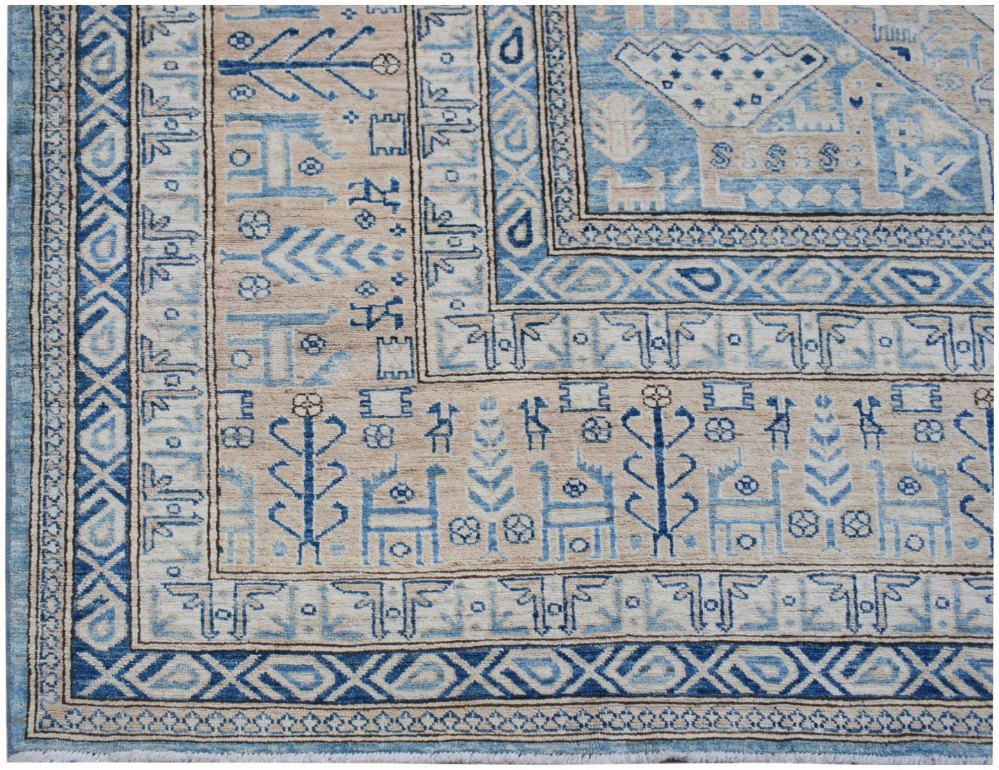 A handmade Afghan Super Kazakh rug featuring traditional blue and beige geometric motifs.
