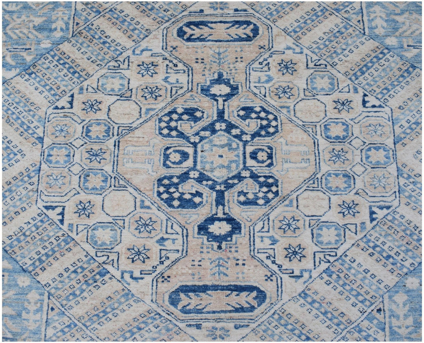 Handmade Afghan Super Kazakh rug featuring a traditional blue and beige geometric medallion design.