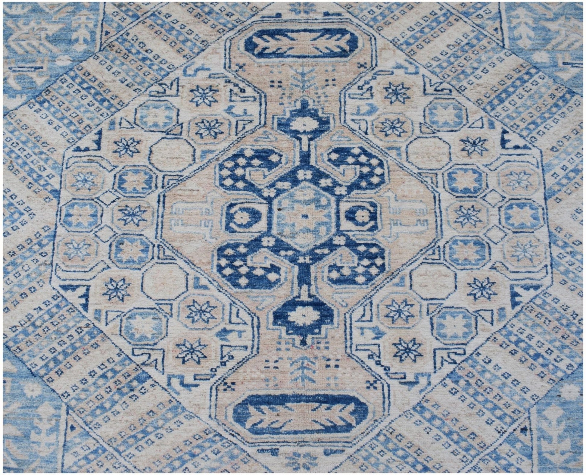 Handmade Afghan Super Kazakh rug featuring a traditional blue and beige geometric medallion design.