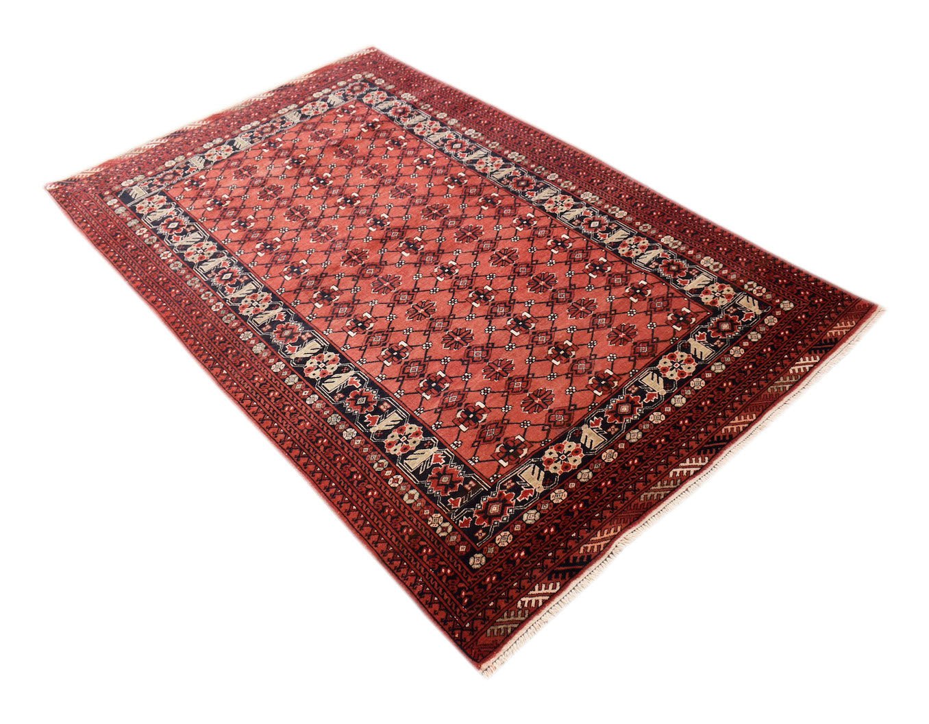 A vintage handmade Afghan Turkmen rug featuring a red field with geometric elephant foot motifs.