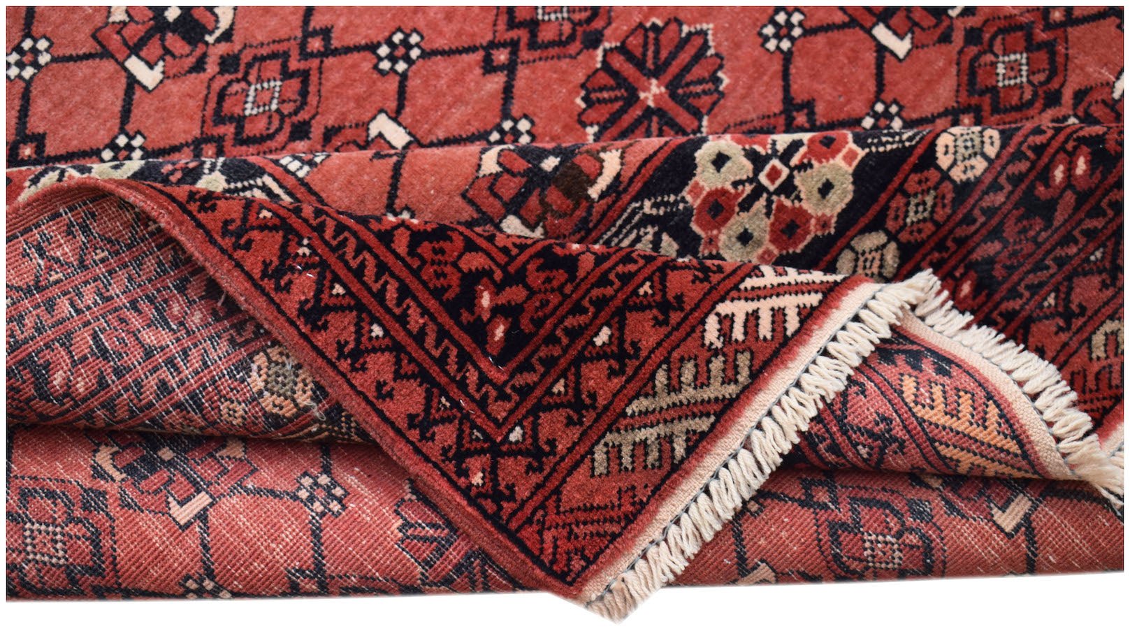 A vintage handmade Afghan Turkmen wool rug featuring a geometric elephant foot pattern in red.