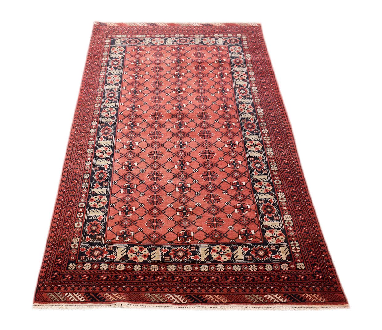 A vintage Afghan Turkmen rug featuring a repeating geometric elephant foot motif in red and black.