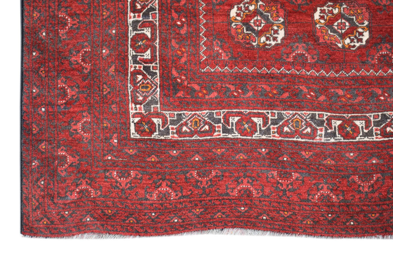 A vintage Afghan Turkmen rug featuring traditional geometric patterns in deep red and charcoal.