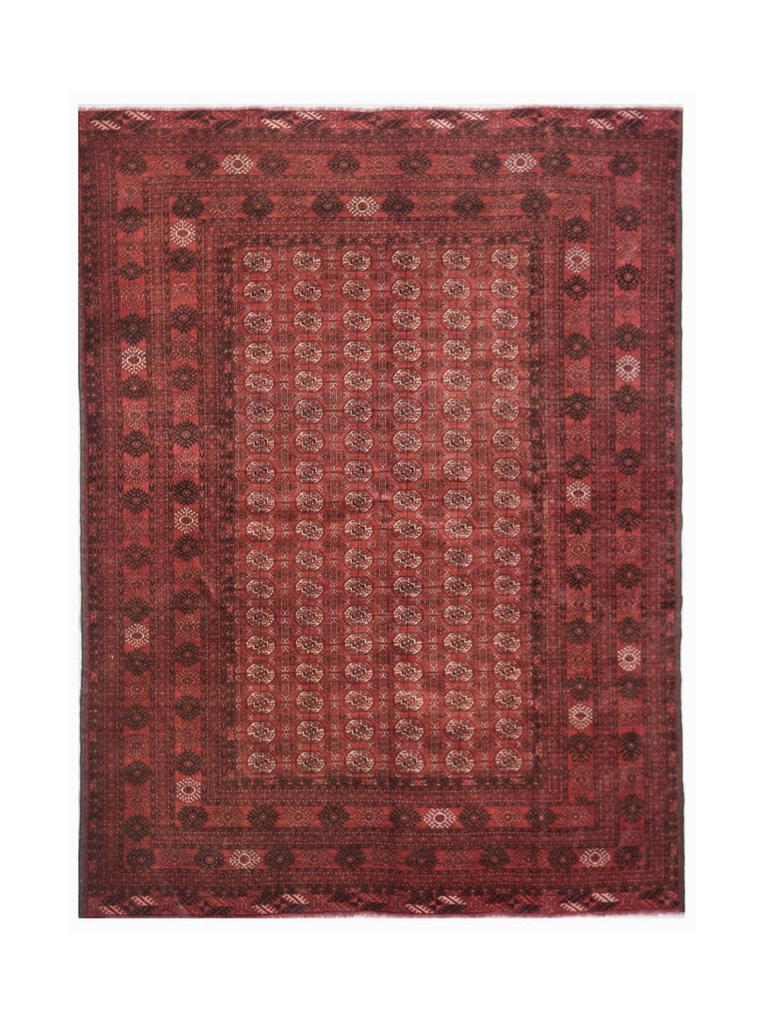 A vintage handmade Afghan Turkmen rug featuring a deep red field with repeating elephant foot motifs.