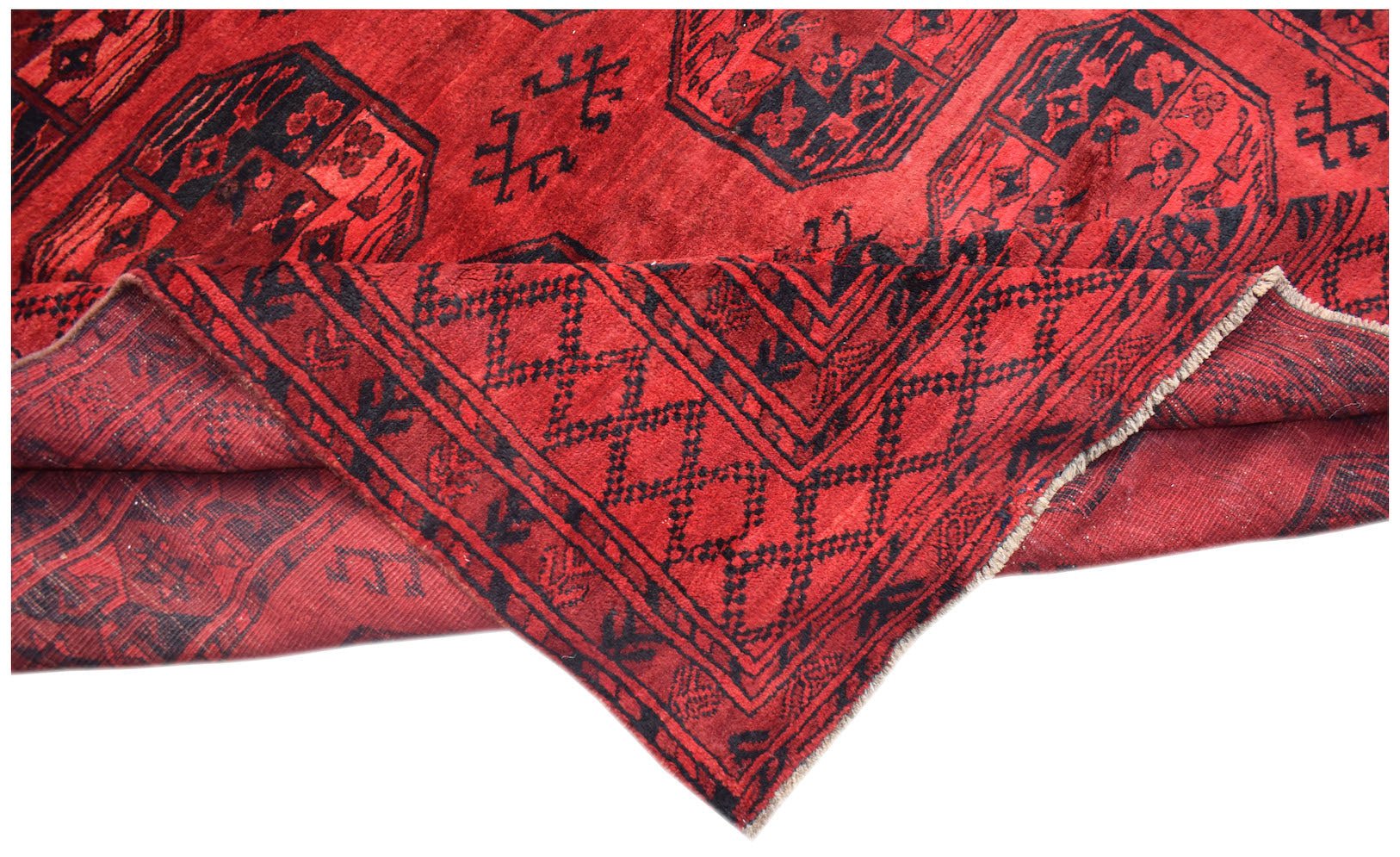 A vintage handmade Afghan Turkmen rug featuring a red field with black elephant foot motifs.