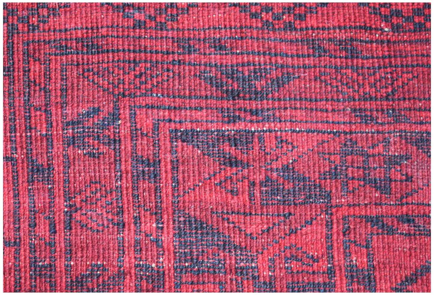 Vintage Afghan Turkmen rug with red and navy geometric patterns.