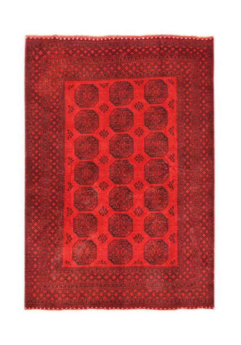 A vintage Afghan Turkmen rug featuring a repeating red and black elephant foot motif.