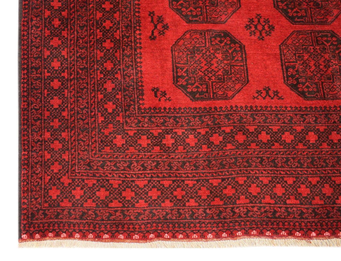 A vintage handmade Afghan Turkmen rug featuring a red field with black geometric elephant foot motifs.