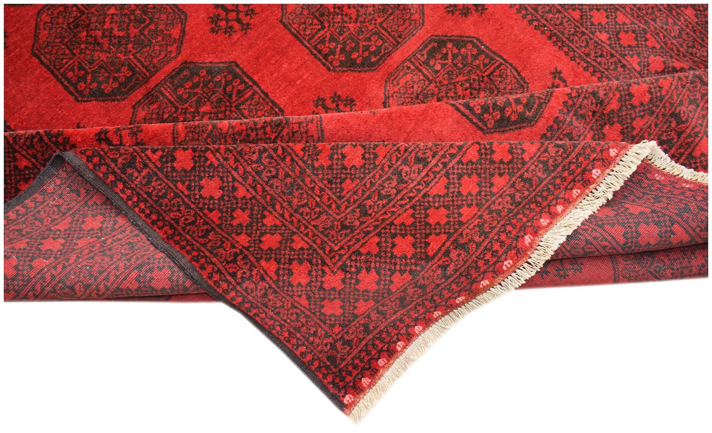 A vintage Afghan Turkmen rug featuring a red background with black elephant foot motifs.
