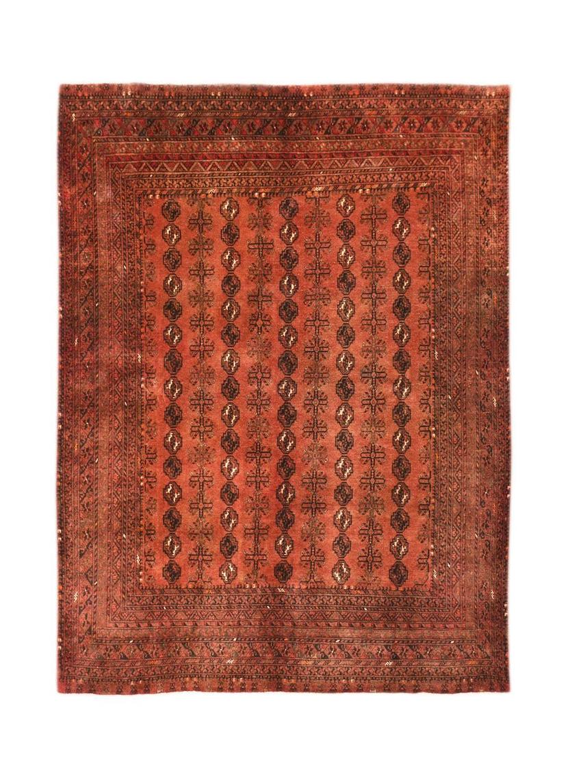 A vintage handmade Afghan Turkmen rug featuring a repeating geometric elephant foot motif in red.