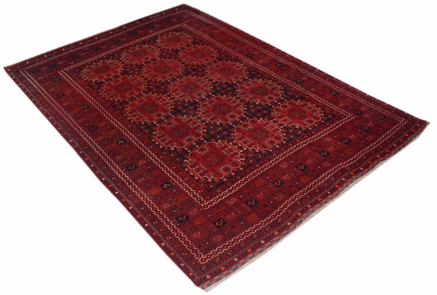 A vintage handmade Afghan Turkmen rug featuring a repeating red elephant foot motif.