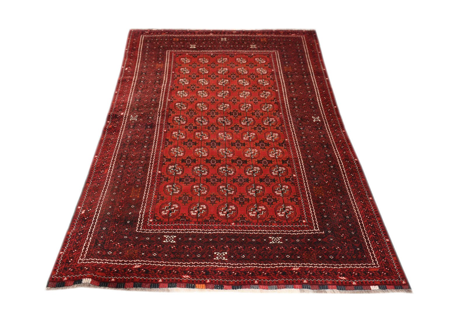 A vintage handmade Afghan Turkmen rug featuring a repeating red elephant foot motif.