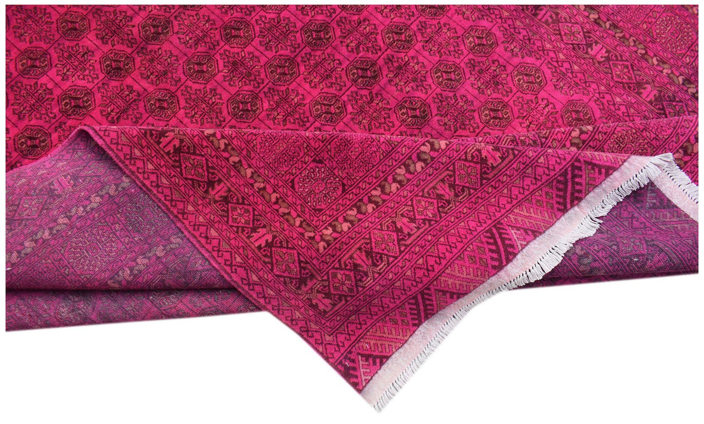A vintage Afghan Turkmen rug featuring a repeating geometric elephant foot pattern in magenta.