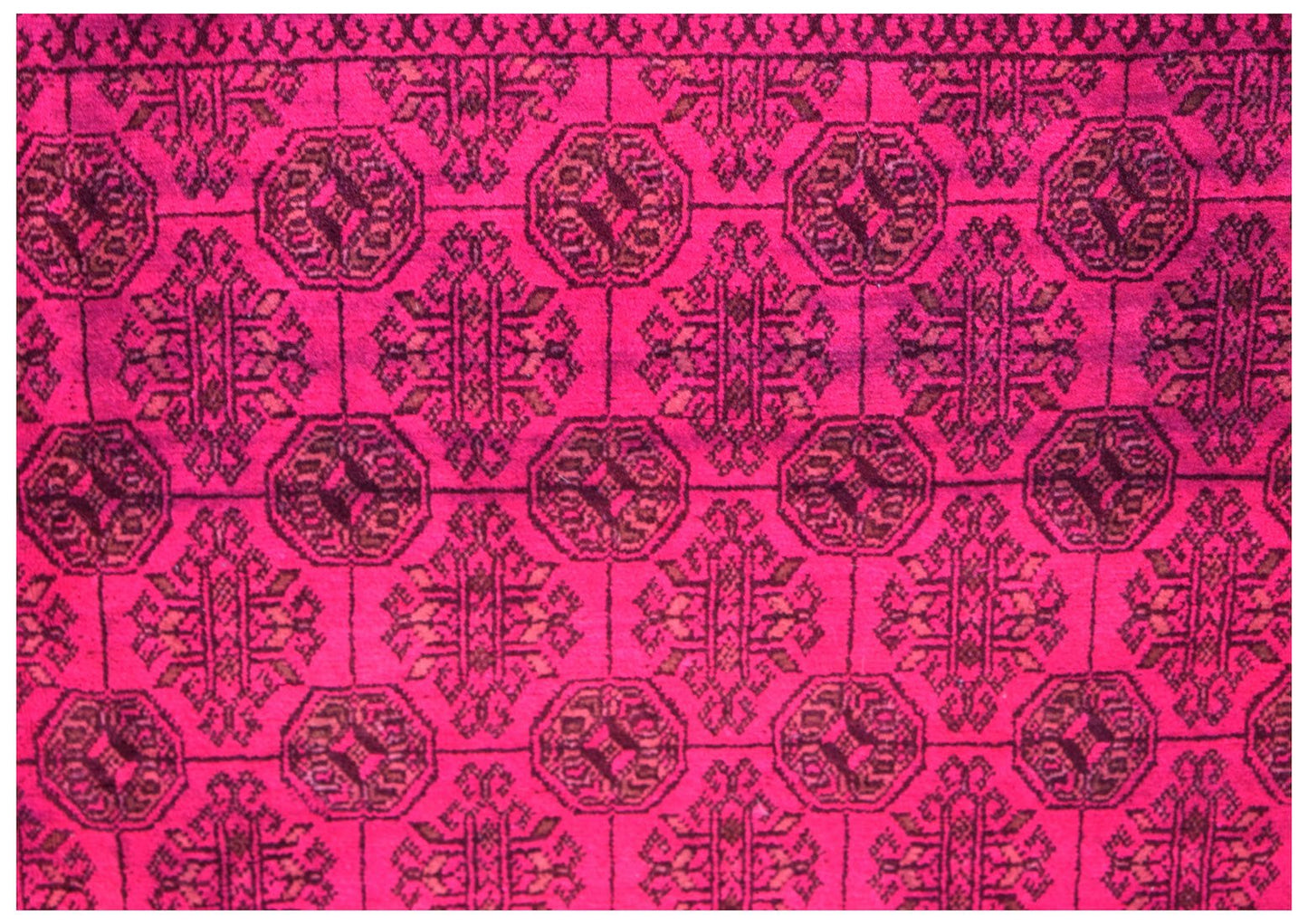 A vintage Afghan Turkmen rug featuring a repeating geometric elephant foot motif in deep pink.