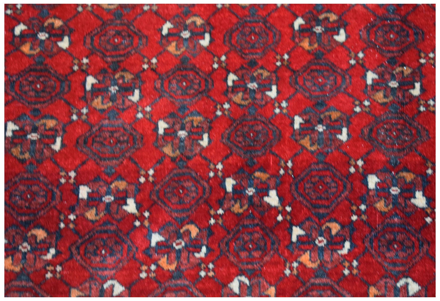 Vintage Afghan Turkmen rug with a red background and geometric patterns.
