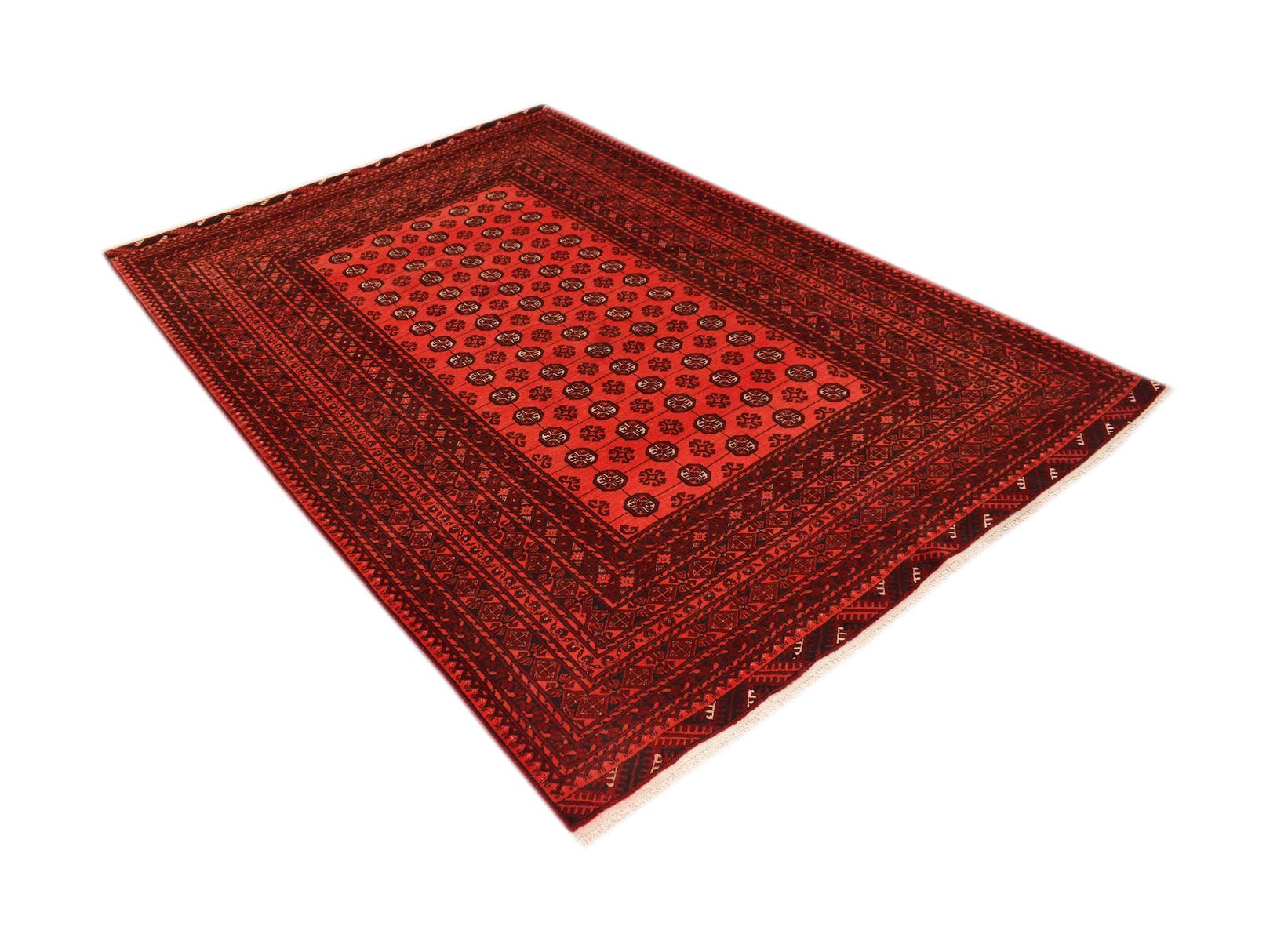 A vintage handmade Afghan Turkmen rug featuring a red field with repeating elephant foot motifs.