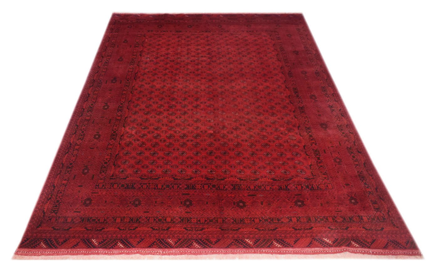 A vintage handmade Afghan Turkmen rug featuring a repeating red elephant foot motif.